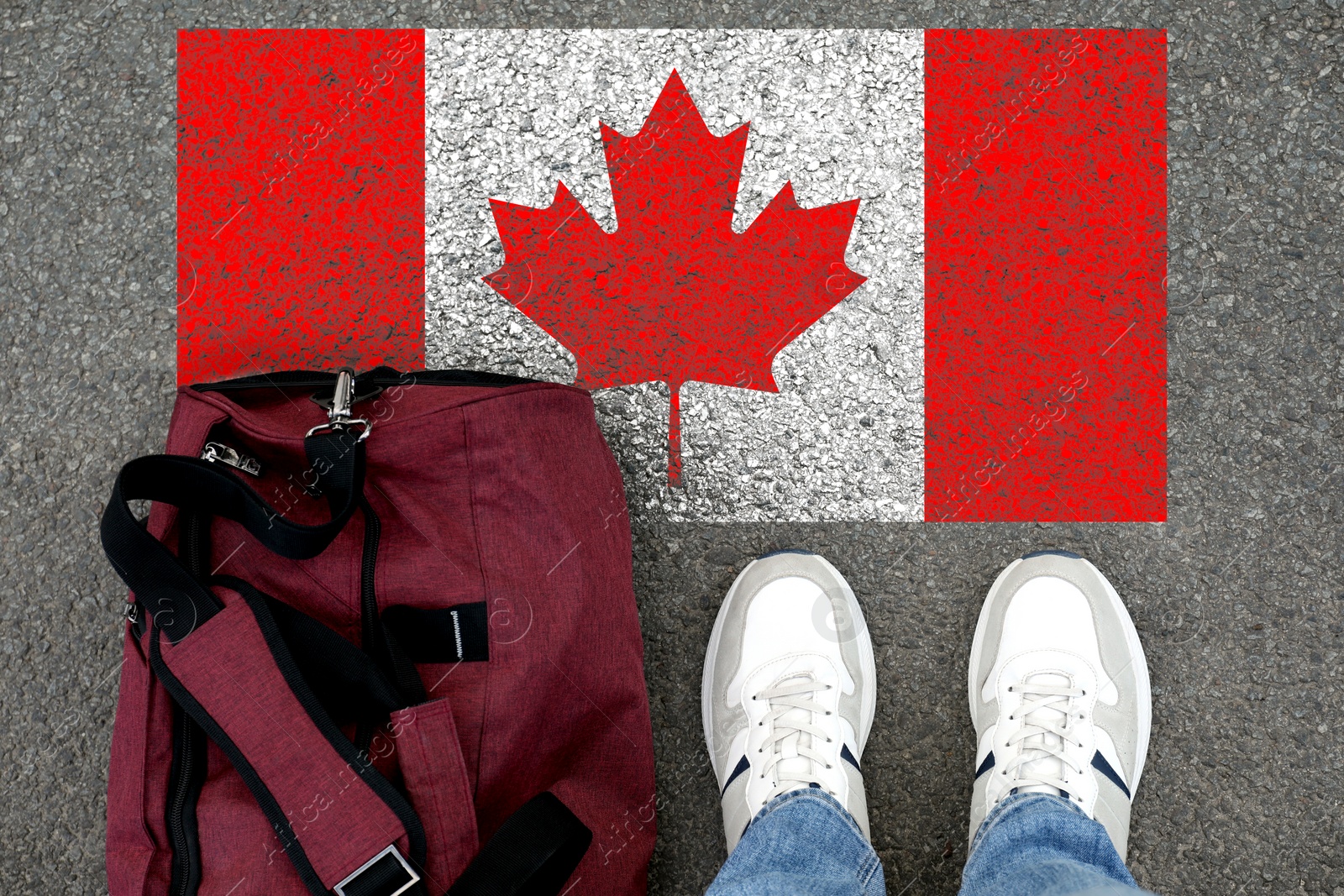 Image of Immigration. Man with bag standing on asphalt near flag of Canada, top view