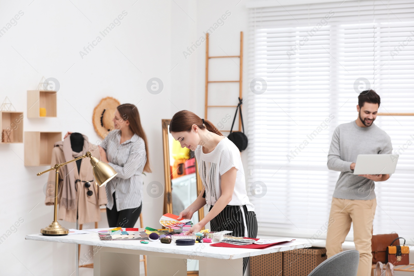 Photo of Fashion designers creating new clothes in studio