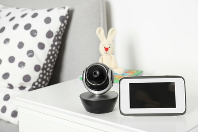 Photo of Baby monitor with camera on table in room. Video nanny