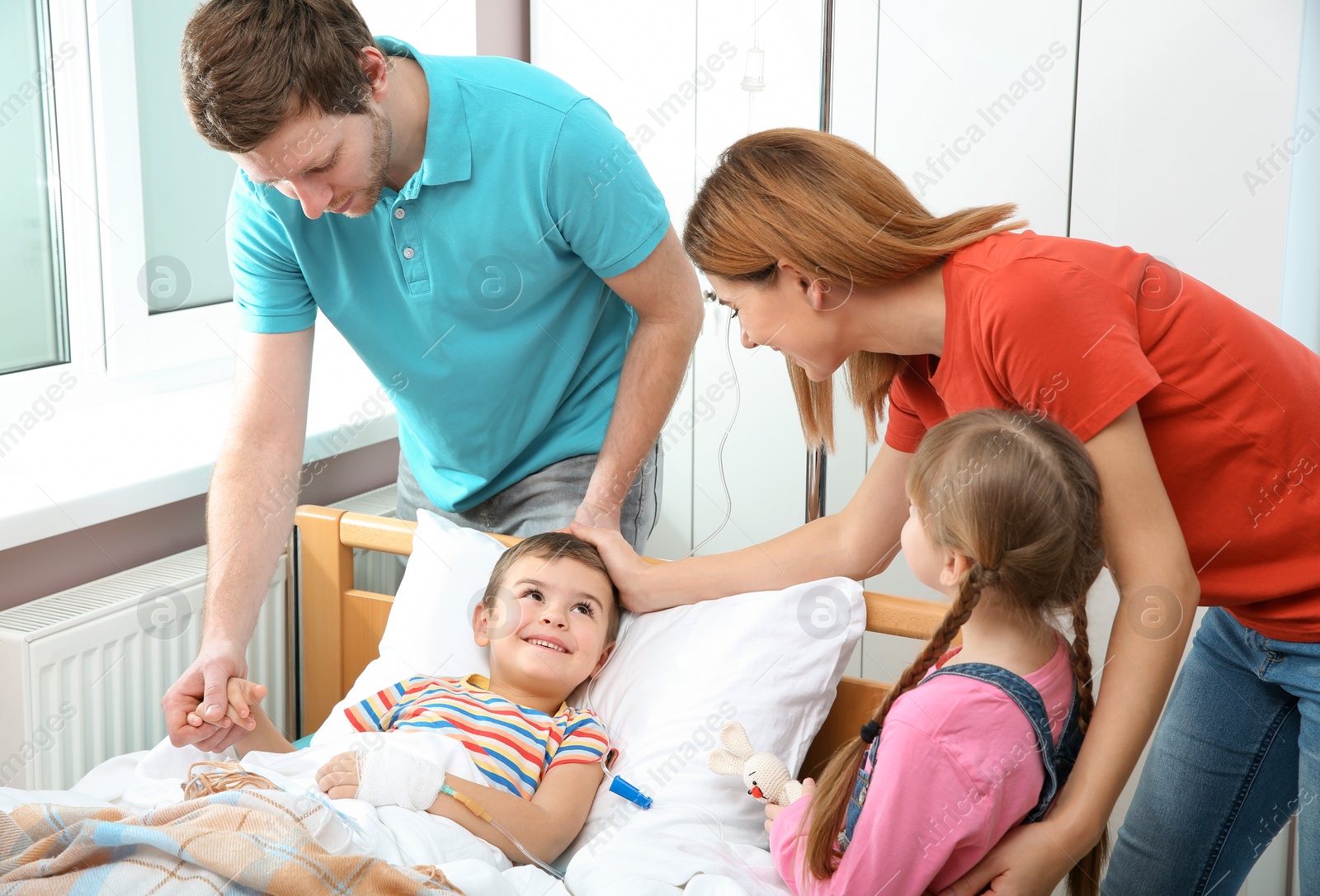 Photo of Happy family visiting little child in hospital