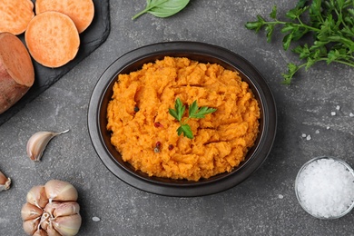 Flat lay composition with mashed sweet potatoes on grey background