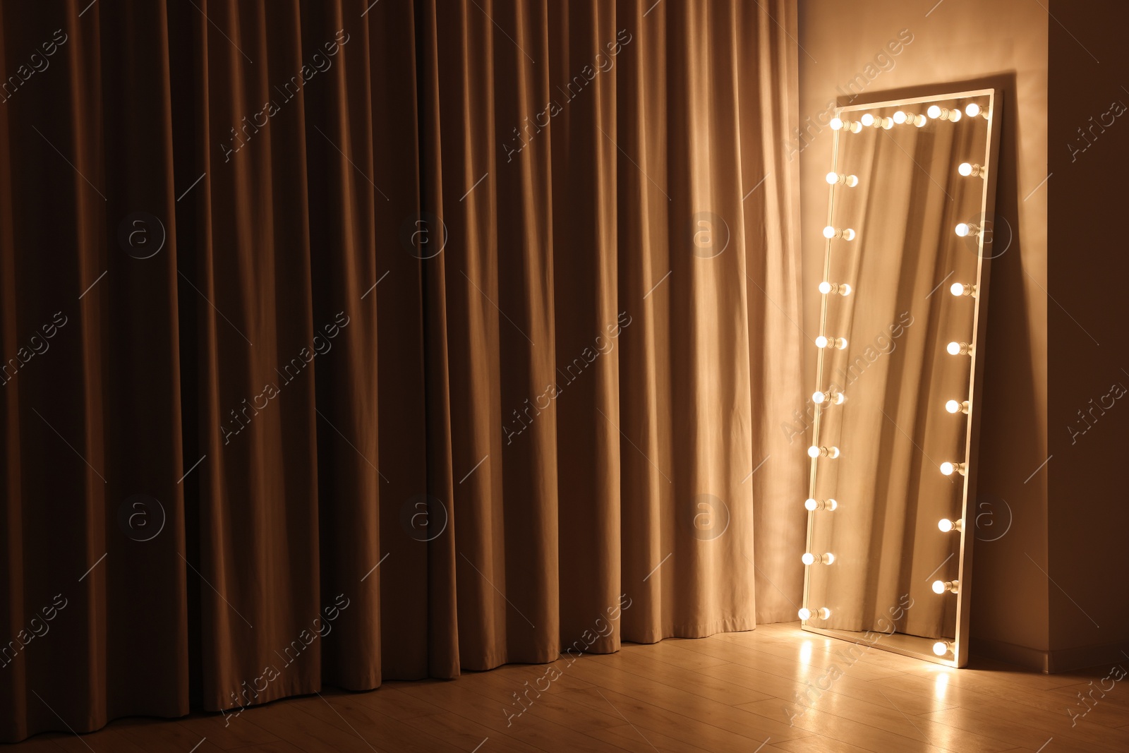 Photo of Modern mirror with light bulbs in makeup room