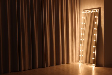 Modern mirror with light bulbs in makeup room