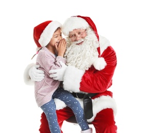 Photo of Little girl whispering in authentic Santa Claus' ear against white background