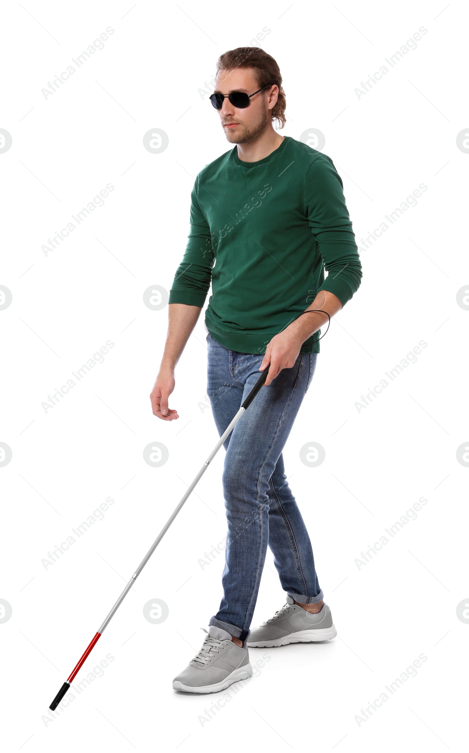 Photo of Blind man in dark glasses with walking cane on white background