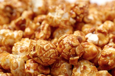 Photo of Sweet tasty caramel popcorn as background, closeup