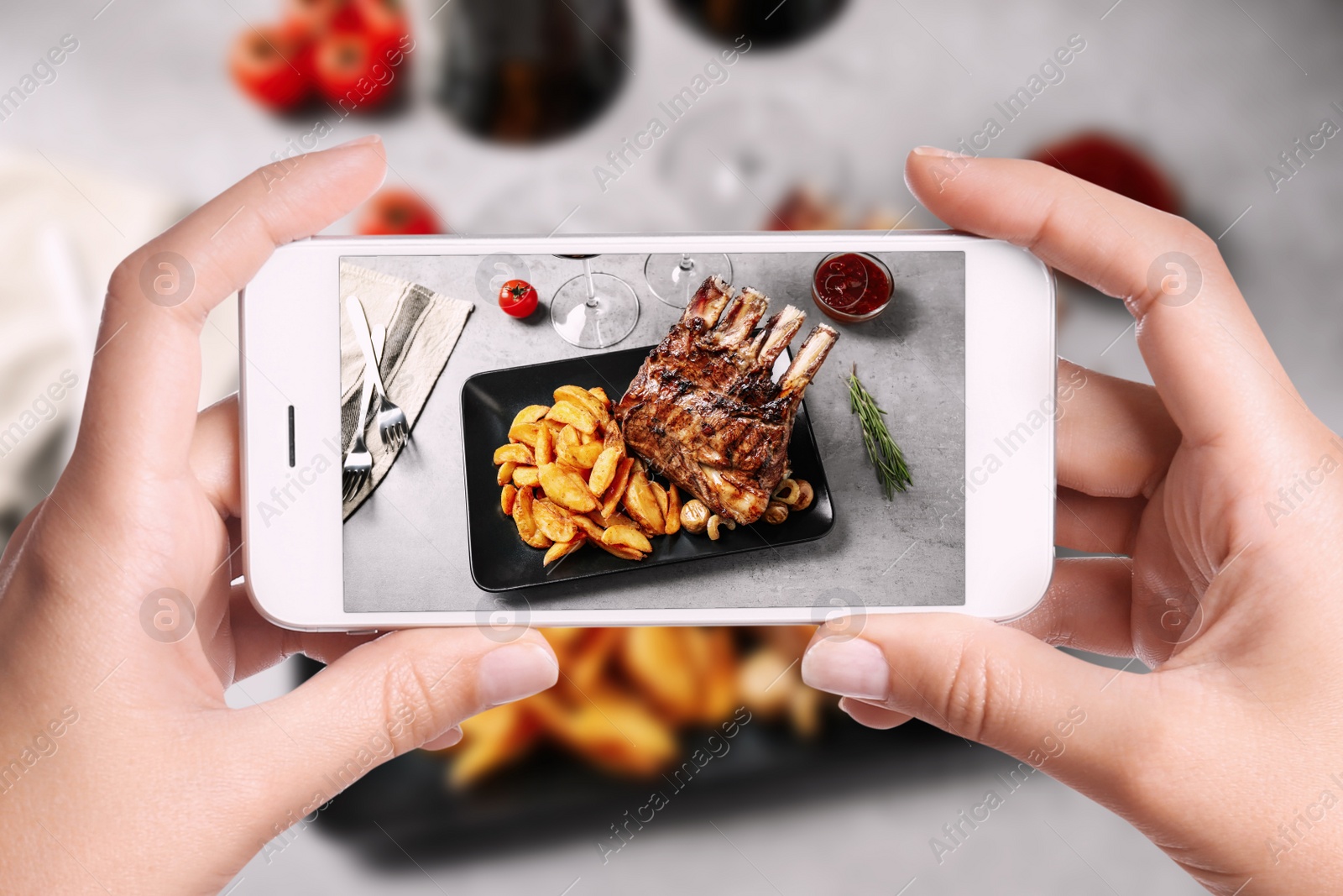 Image of Blogger taking picture of delicious grilled ribs at table, closeup. Food photography