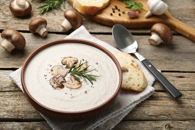 Photo of Fresh homemade mushroom soup served on wooden table