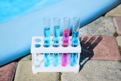 Photo of Test tubes with reagents in rack near swimming pool
