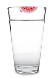 Photo of Glass of water with lipstick mark on white background