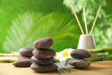 Photo of Composition with stones on table against blurred background. Zen concept