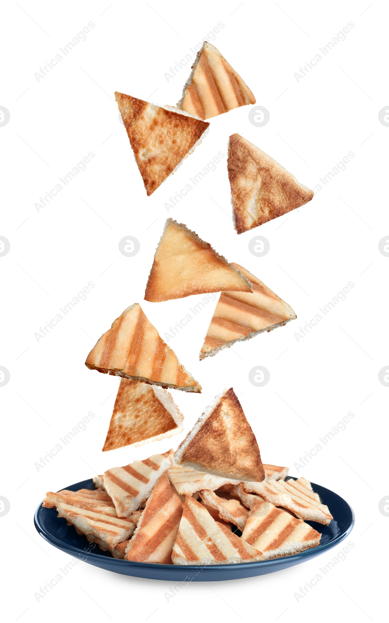 Image of Delicious crispy pita chips falling into plate on white background