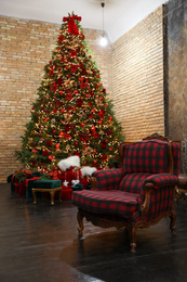 Photo of Festive room interior with stylish armchair and beautiful Christmas tree