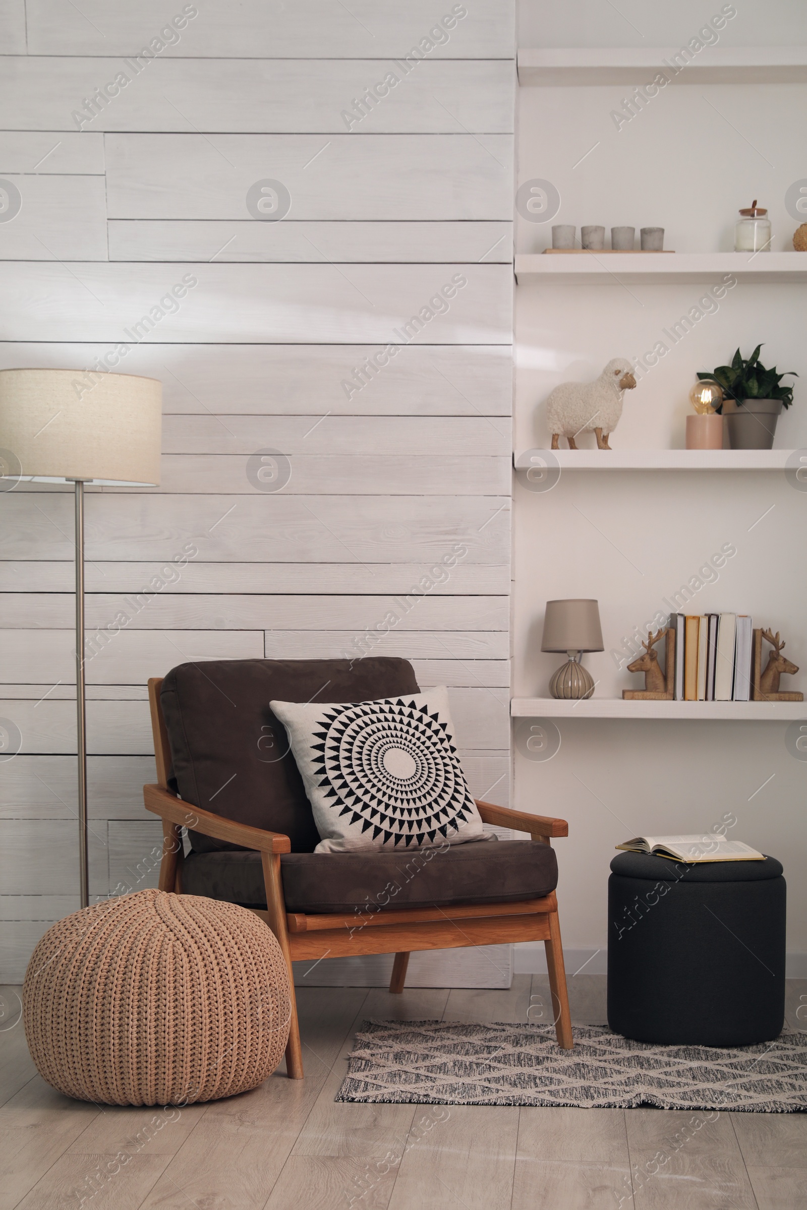 Photo of Stylish comfortable poufs near armchair in room. Home design