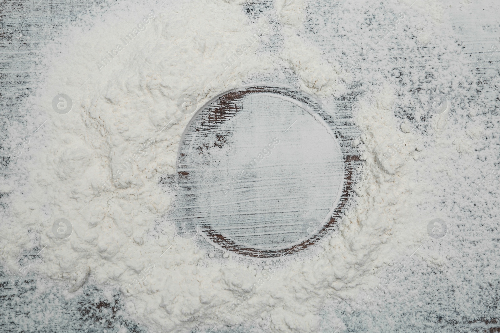 Photo of Flour on wooden background, top view. Space for text