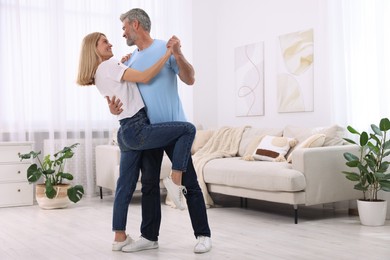 Photo of Happy affectionate couple dancing at home, space for text. Romantic date