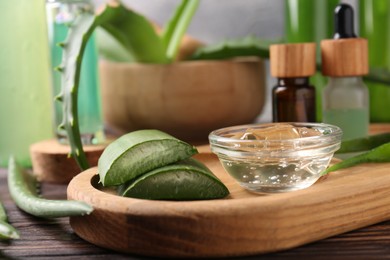 Homemade aloe gel and fresh ingredients on wooden table, closeup