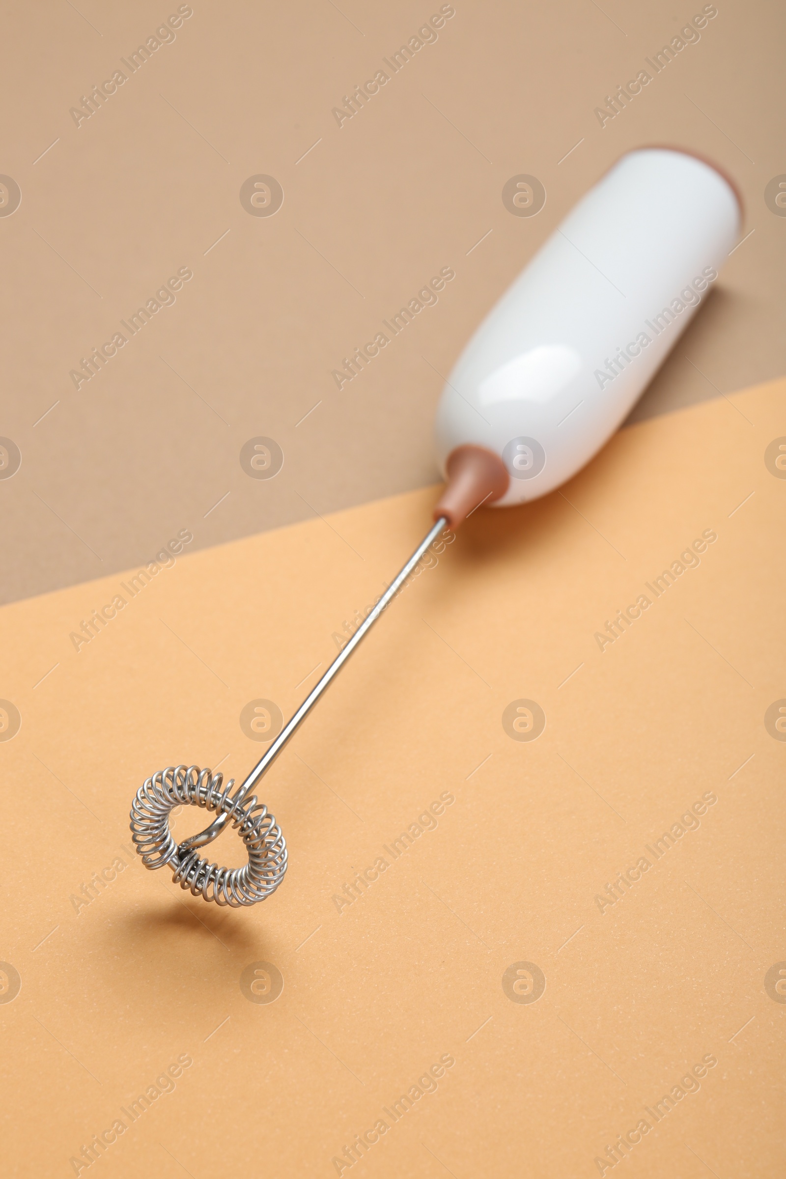 Photo of White milk frother wand on color background