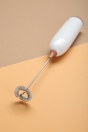 Photo of White milk frother wand on color background