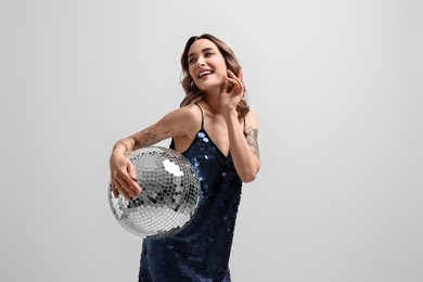 Photo of Beautiful woman with disco ball on white background