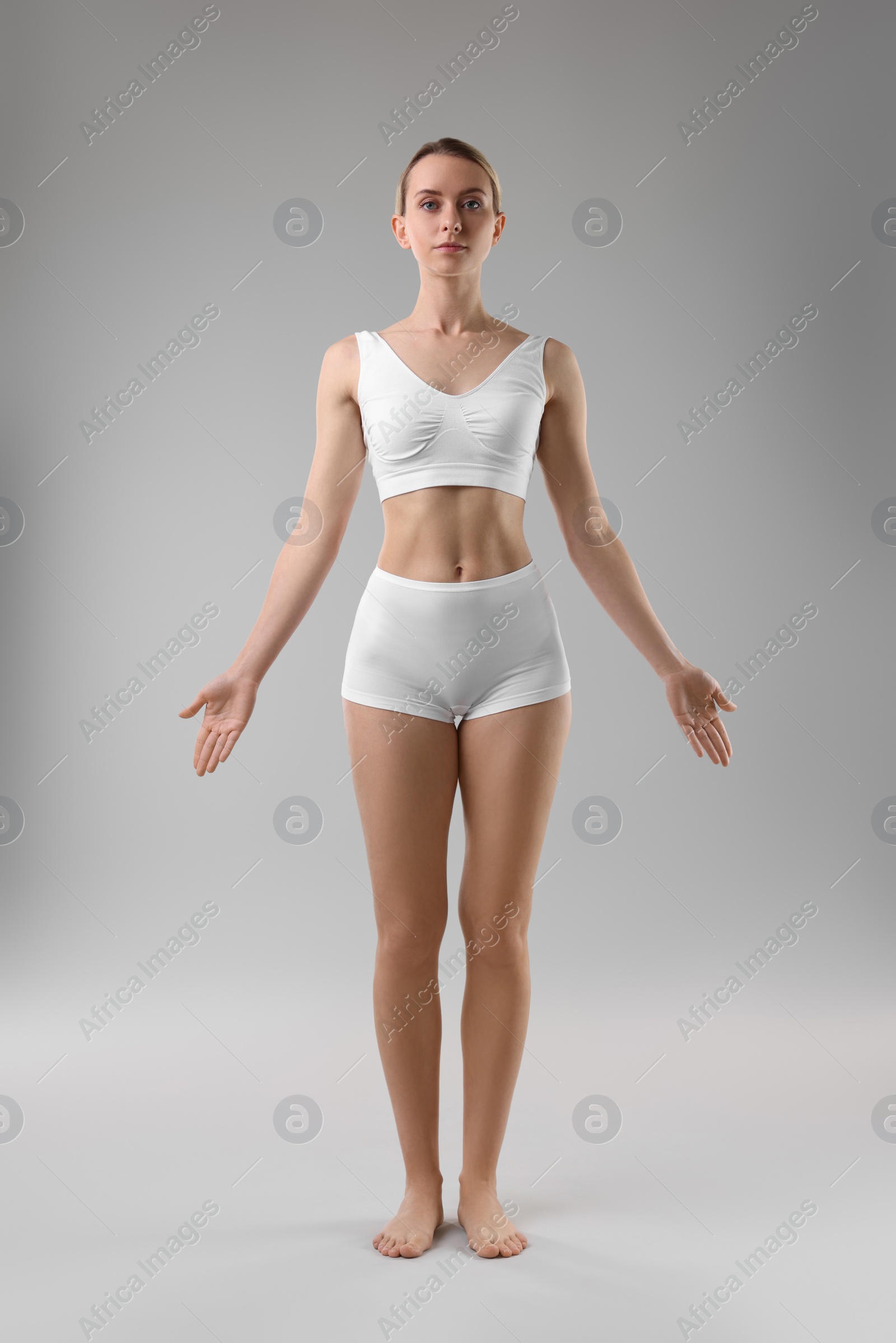 Photo of Full length portrait of sporty woman on grey background