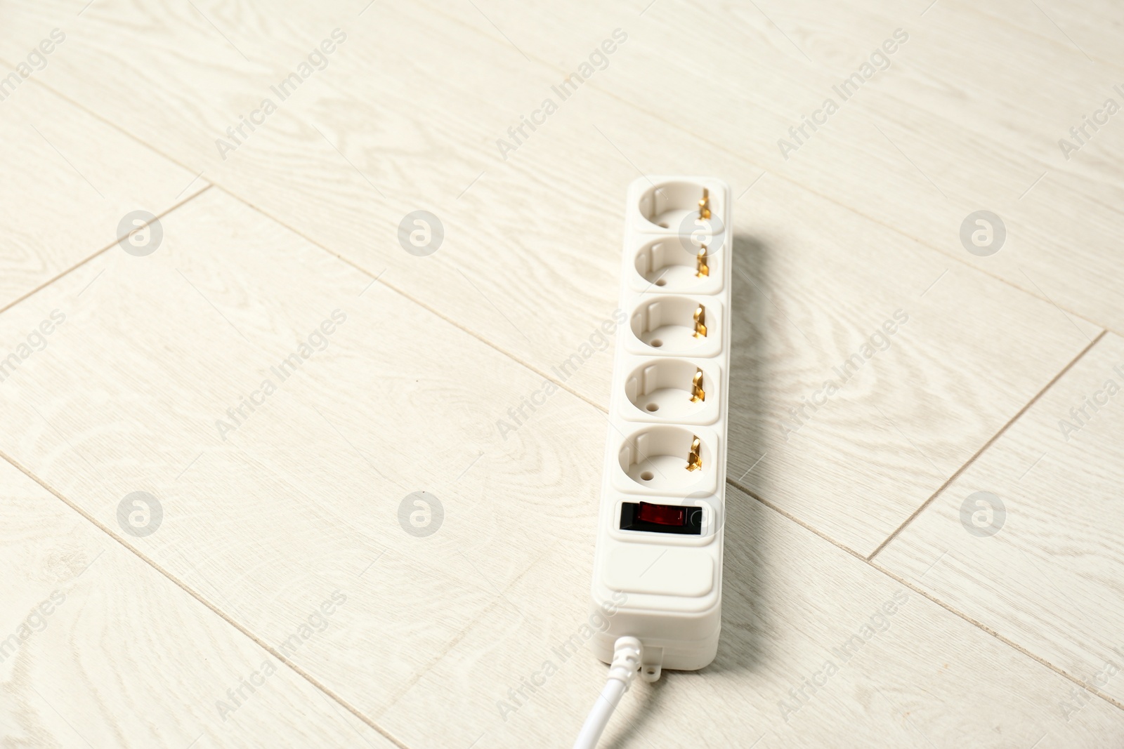 Photo of Extension cord on floor, space for text. Electrician's professional equipment