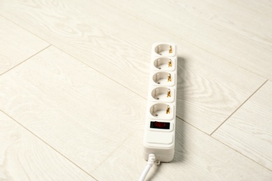 Photo of Extension cord on floor, space for text. Electrician's professional equipment