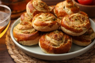 Photo of Fresh delicious puff pastry with tasty filling on wooden table, closeup