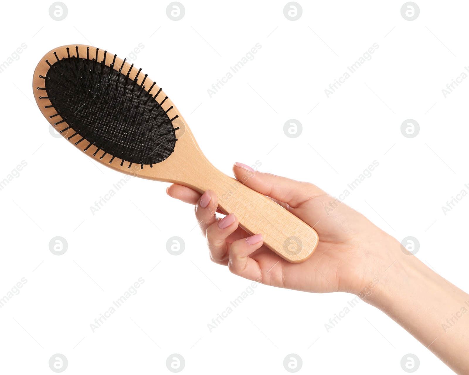 Photo of Woman holding wooden hair brush against white background, closeup