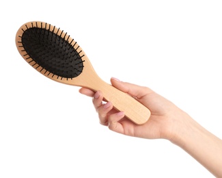 Photo of Woman holding wooden hair brush against white background, closeup