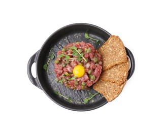 Photo of Tasty beef steak tartare served with yolk, capers and sliced bread isolated on white, top view