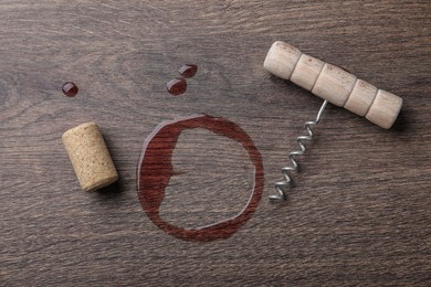 Photo of Wine stain, corkscrew and stopper on wooden table, flat lay