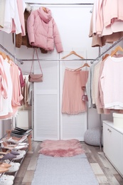 Modern dressing room with different stylish clothes and accessories