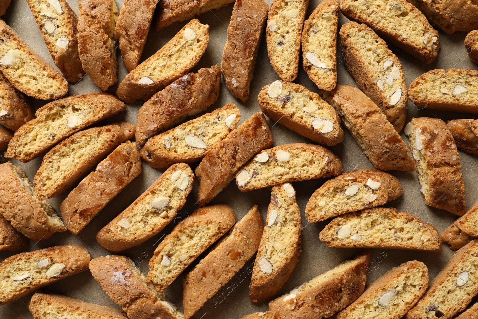 Photo of Traditional Italian almond biscuits (Cantucci) on parchment paper, top view