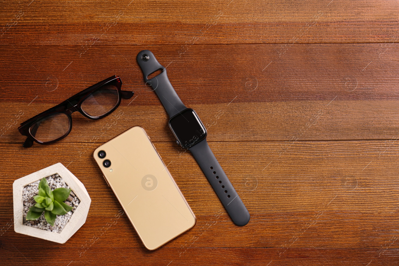 Flat lay composition with stylish smart watch on wooden table. Space for text Photo of Flat lay composition with stylish smart watch on wooden table. Space for text