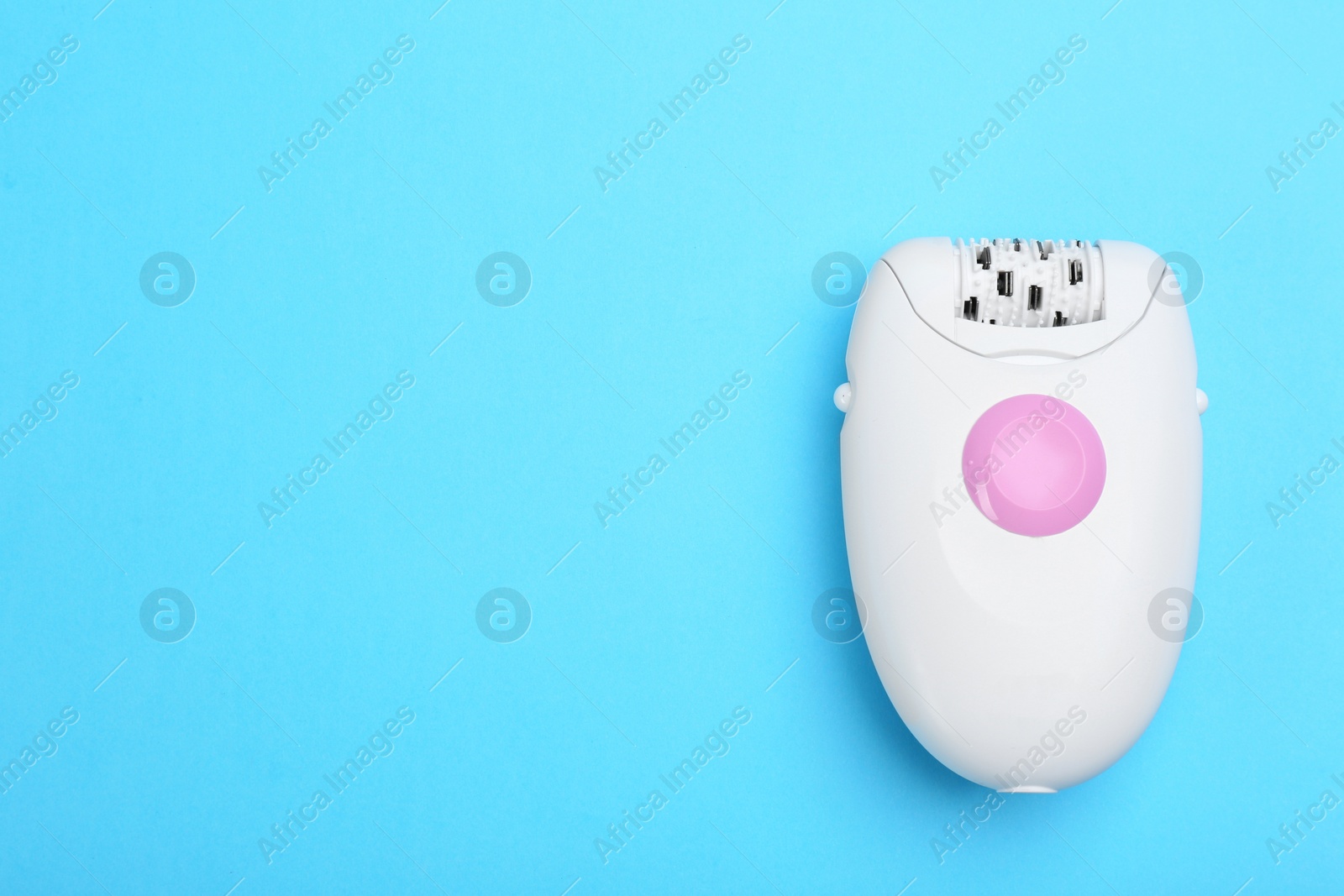 Photo of Modern epilator on blue background, top view. Space for text
