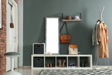 Photo of Stylish hallway interior with mirror and hanger stand