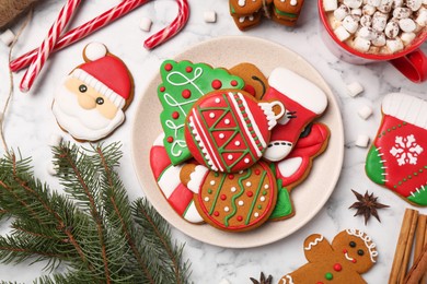 Flat lay composition with decorated Christmas cookies on white marble table