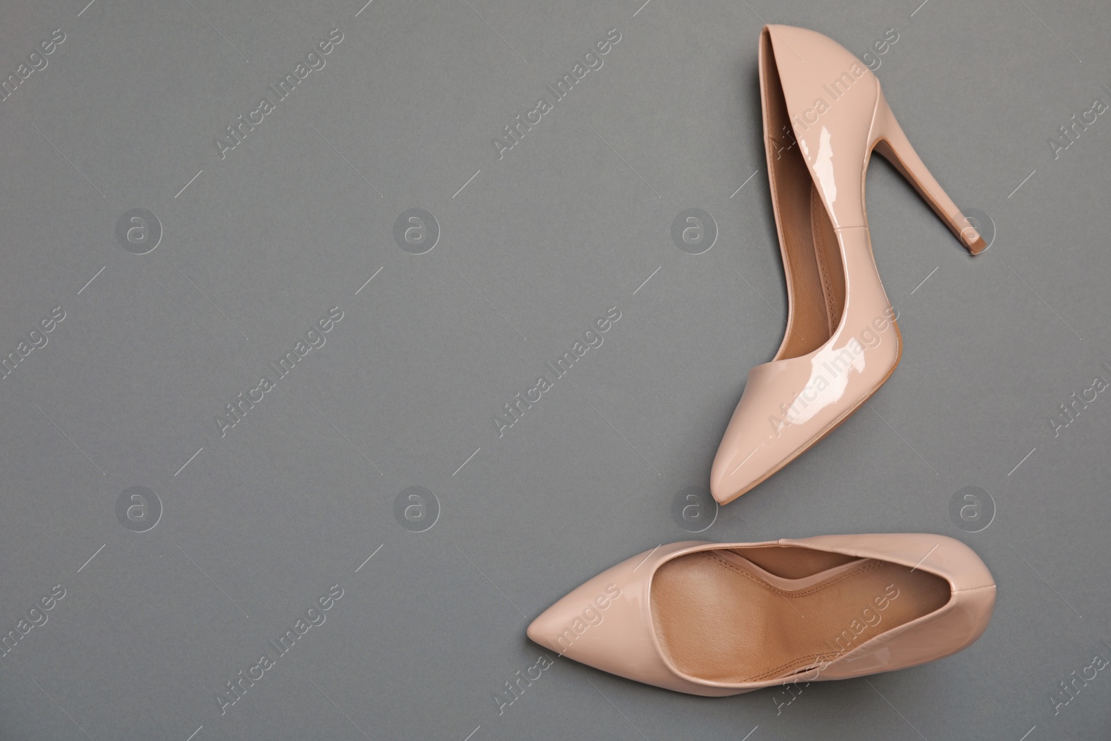 Photo of Pair of beautiful shoes and space for text on color background, top view