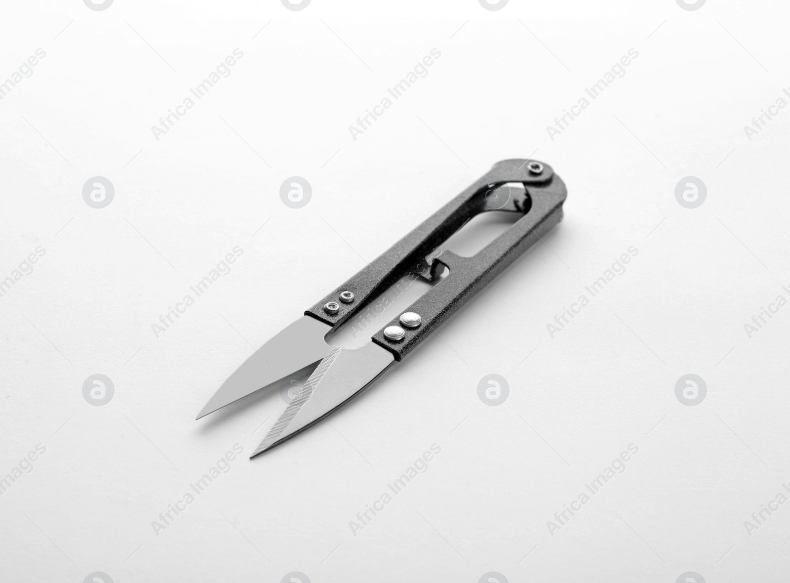 Photo of Pair of sewing scissors on white background