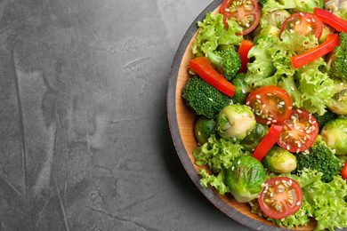 Photo of Tasty salad with Brussels sprouts on grey table, top view. Space for text