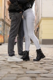 Lovely couple enjoying time together outdoors, closeup. Romantic date