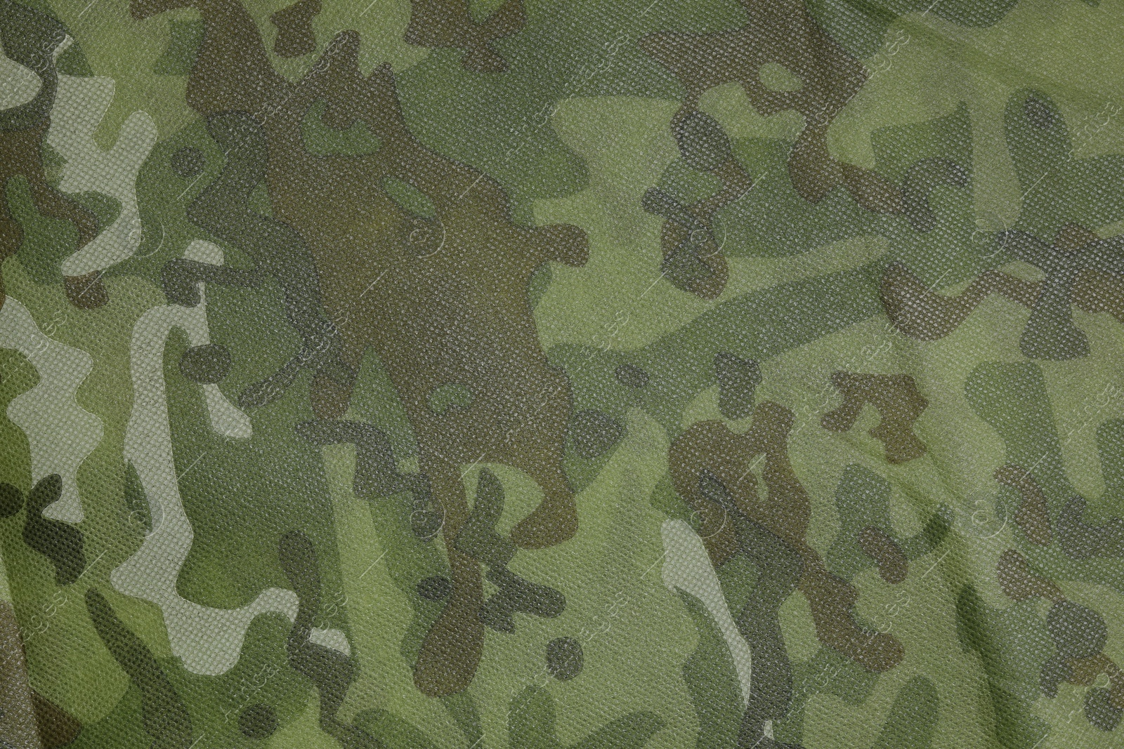 Photo of Texture of camouflage fabric as background, top view