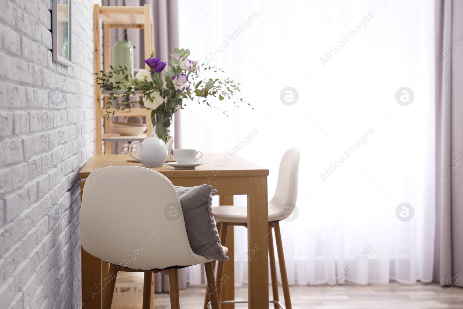 Photo of Stylish room interior with wooden dining table