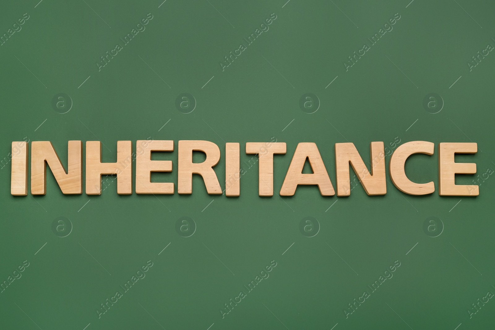 Photo of Word Inheritance made with wooden letters on green background, flat lay