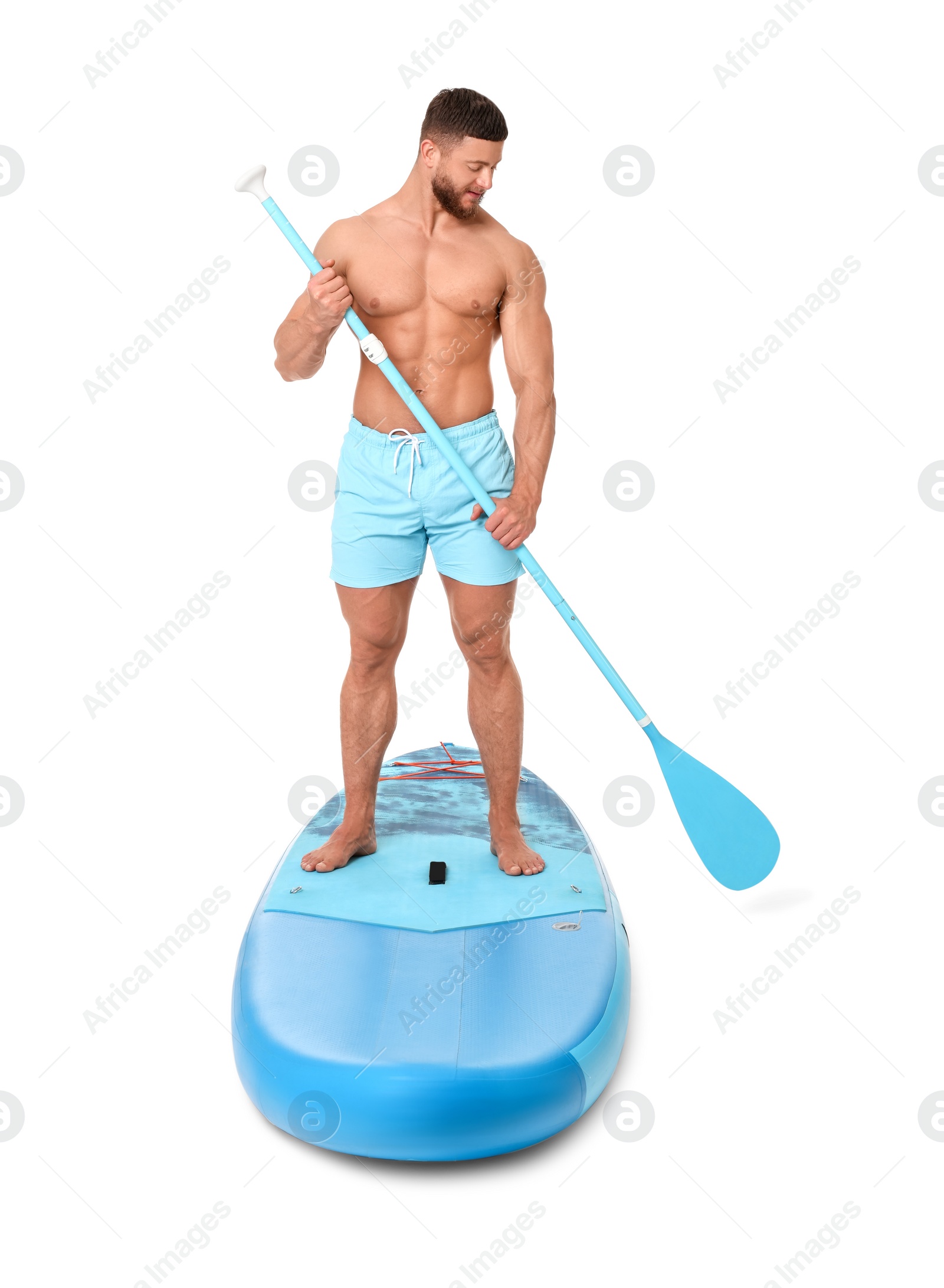 Photo of Handsome man with paddle on blue SUP board against white background