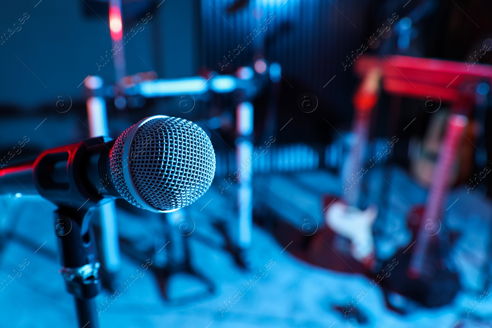 Photo of Modern microphone at recording studio, color toned. Music band practice