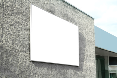 Photo of Blank banner on building facade outdoors. Advertising board design