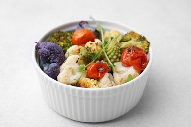 Photo of Delicious salad with cauliflower and tomato on white table, closeup