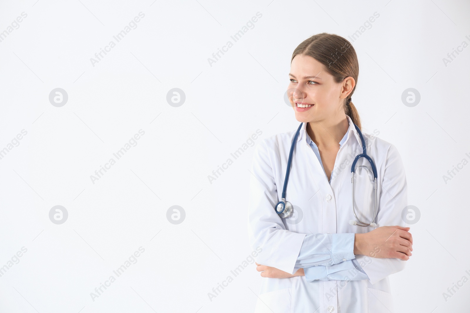Photo of Portrait of young doctor against white background